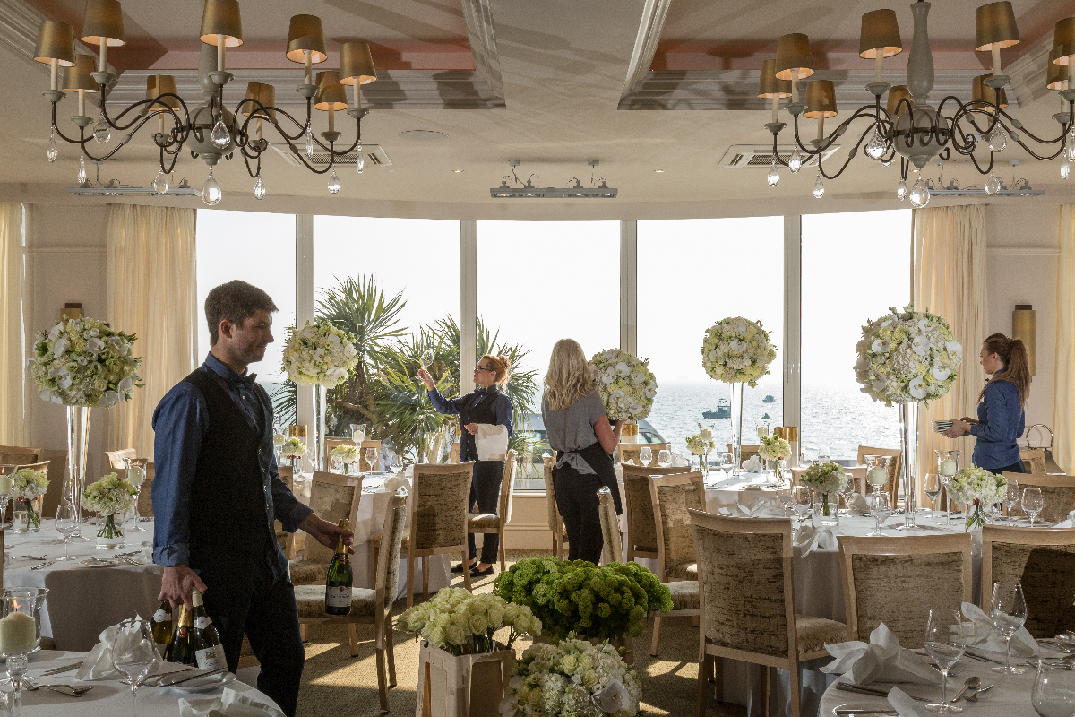 An image of staff members preparing the Tides banquet room at the Roslin Beach hotel