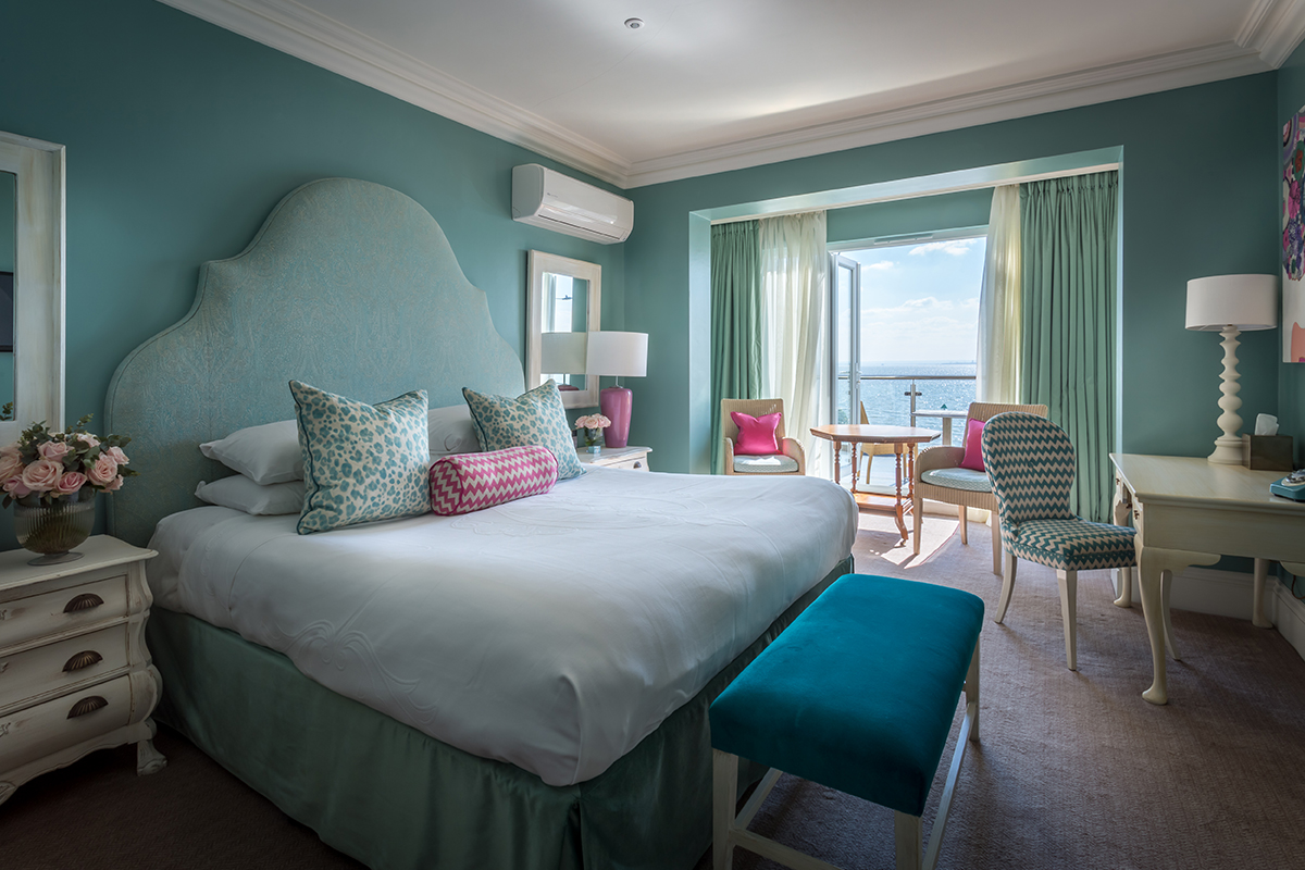 A photo of a luxury guest room at the Roslin Beach Hotel in Southend, with the balcony doors open overlooking the estuary.